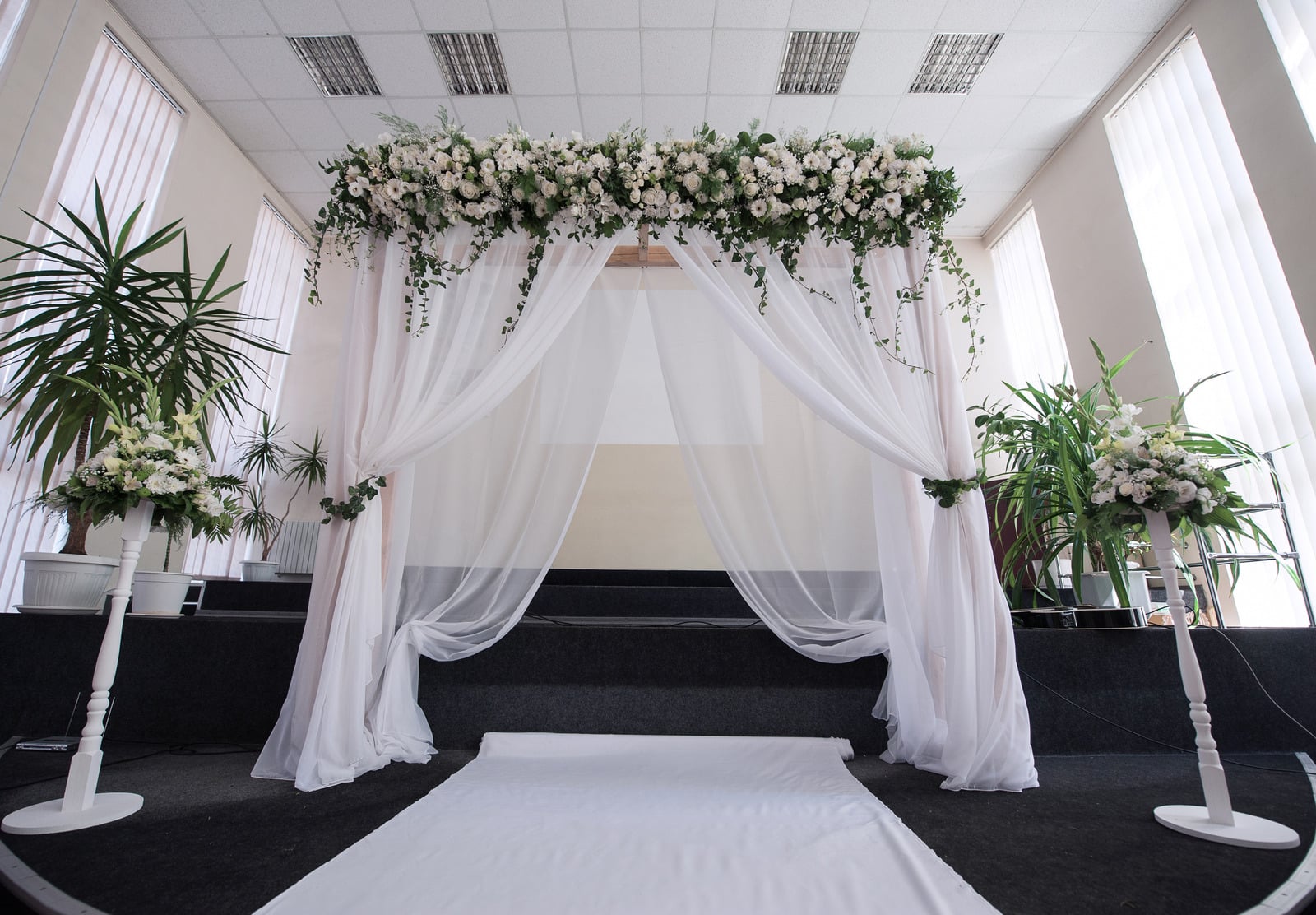 White draped floral chuppah backdrop styled by Gather & Go